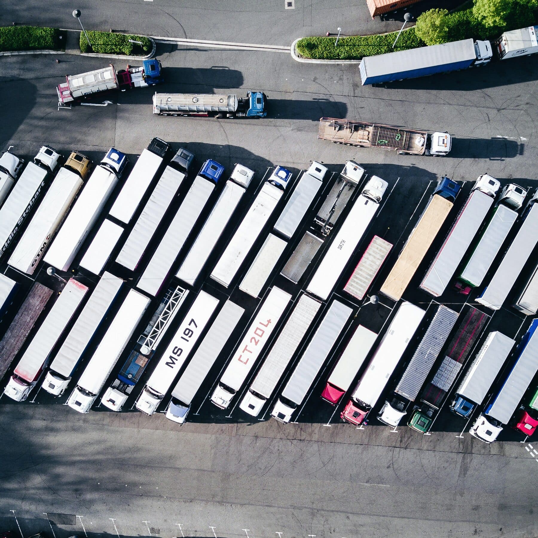 Trailers parked close together at a distribution site, seen from above